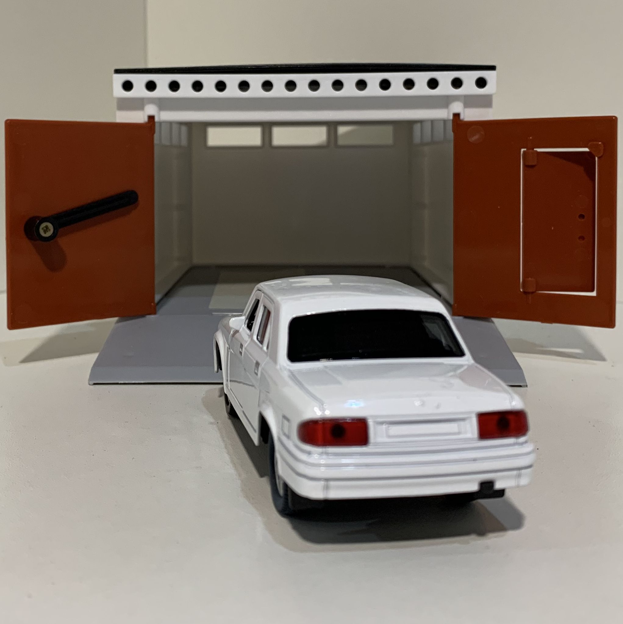 Гаражный бокс с распашными воротами и металлическая инерционная машинка Волга 3110 с открывающимися дверями 12 см - белая